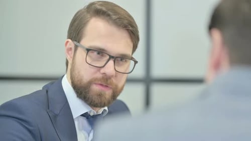 Close Up of Businessman Talking with Partner in Office