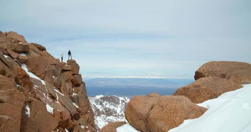 Couple on Top of Rocky Mountains, Close Up View From Peak Adventure