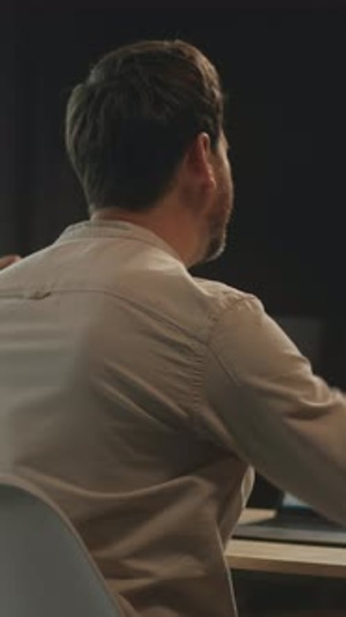 Man Works at Laptop and Celebrates Success