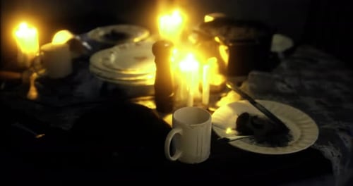 Warm Flickering Candlelight on a Dinner Table