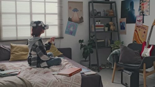 Teenager Wearing Virtual Reality Headset in Bedroom