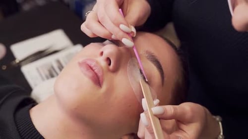 Woman Receiving Eyelash Extension Service Close Up