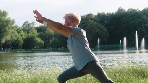 Senior Woman Doing Yoga by Scenic Lake