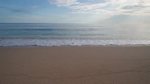 Wide Horizon of Minimalist Tropical Beach with Gentle Blue Wave