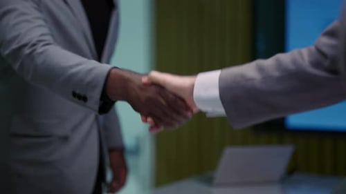 Business Handshake in Modern Office Setting