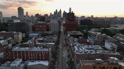 Aerial rising wide shot of Main Street in suburb of Philadelphia. Downtown with skyline in