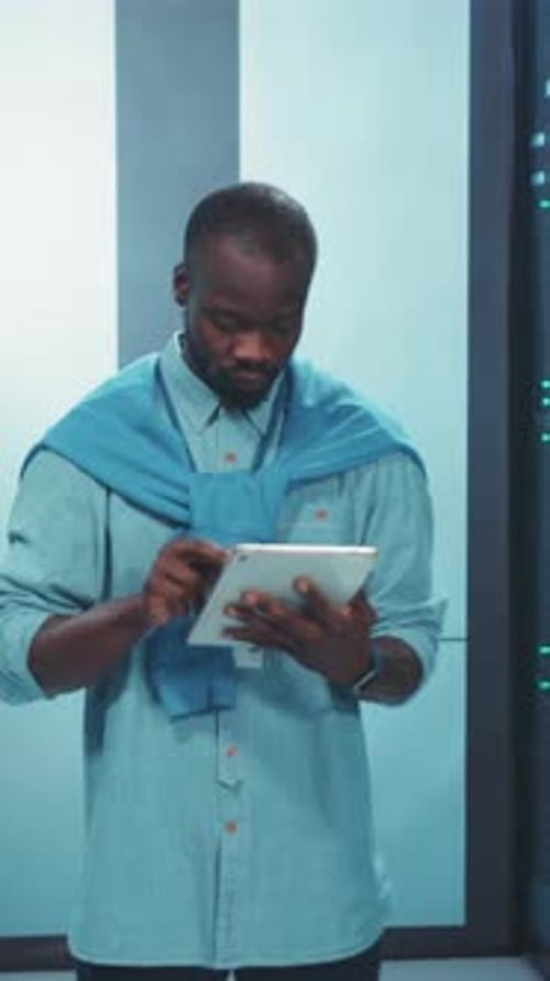 Man Using Tablet in Modern Server Room