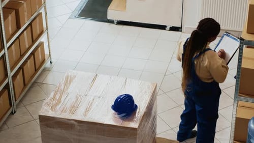 Warehouse Workers Inspecting and Logging Inventory