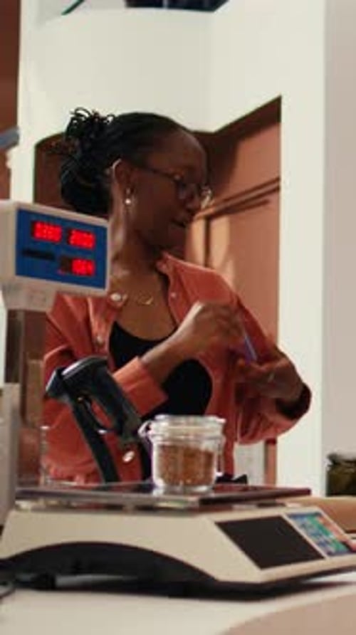 Friendly Saleswoman Helping Customer Pay With Credit Card