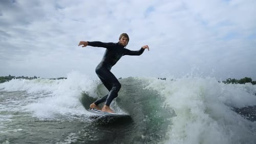 Man wake surfing on lake water during daytime