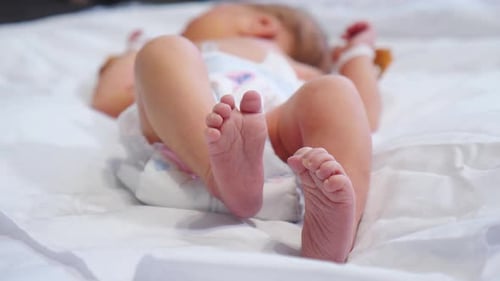 Newborn Baby Lying on Back Moving Feet