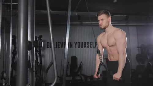 The Sportsman is Doing an Exercise for the Triceps
