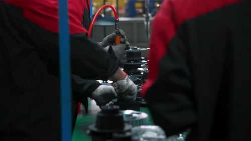 L'opérateur de la chaîne de production utilise une clé dynamométrique électrique pour l'assemblage du moteur