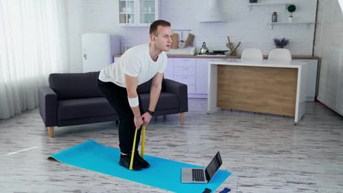 Man Exercising with Resistance Band at Home