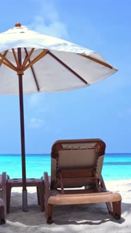 White Sun Umbrellas and Chairs at Seashore Perfect Summer Vacation Vertical