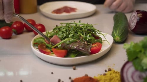 Chef Assembling a Delicious Salad with Meat