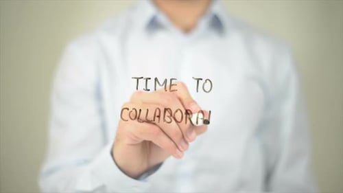 Time to Collaborate Man Writing on Transparent Screen