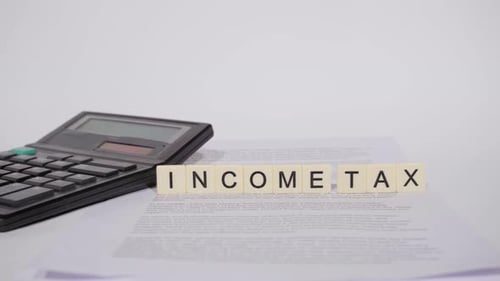 Word INCOME TAX on scrabble