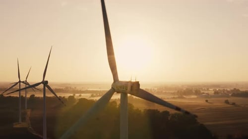 Aerial View of a Wind Turbine Farm During Sunset or Sunrise