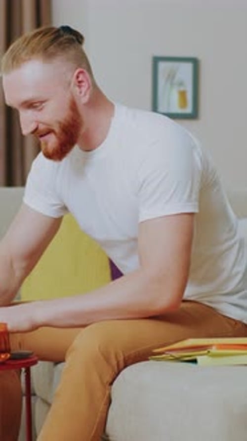 Man Works On Laptop At Home