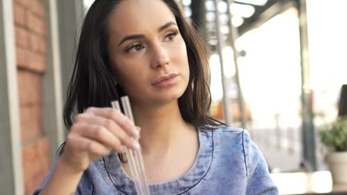 Pensive Beautiful Woman Drinking Cocktail Sitting in Cafe in City 20s