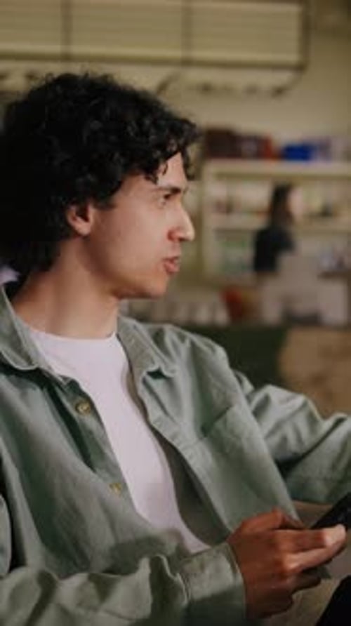 Men working in cafe with laptop and phone