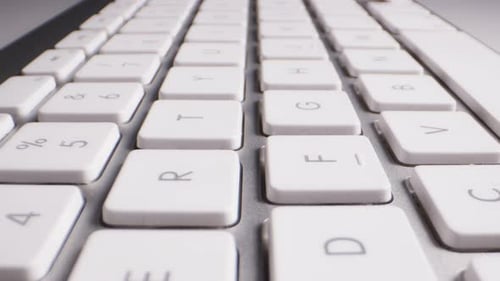 Close-up of Buttons of Wireless White and Silver Keyboard