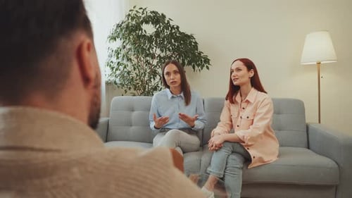 Couple Consulting Therapist in Bright Room, Man Listening