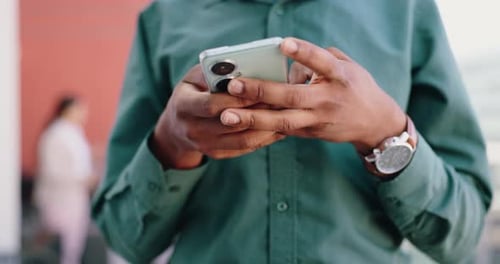 Hands Using Modern Smartphone in Urban Setting