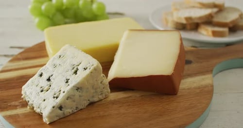 Cheese Selection with Grapes and Bread on Board