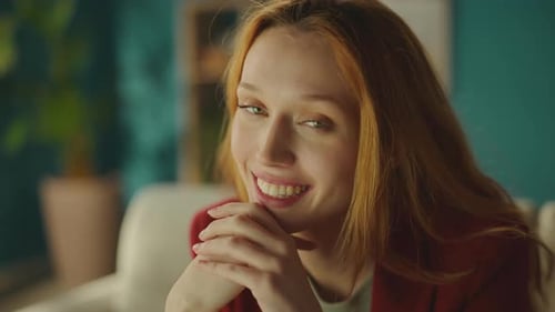 Beautiful Smiling Woman with Auburn Hair Posing Indoors