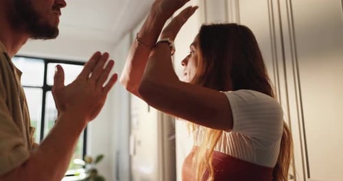 Couple Having an Intense Argument Indoors During Daytime