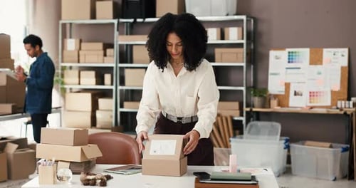 Woman Packaging Box for Shipping in Office