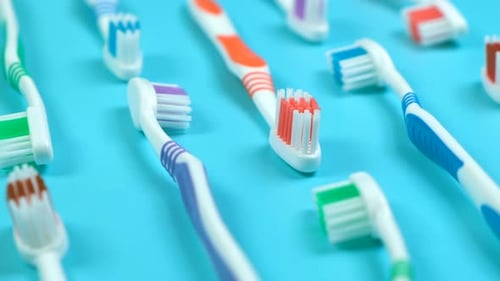 Background Dental Toothbrushes of Different Colors on a Blue Background Top View