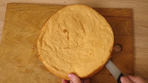 Woman Cutting Cake on Wooden Board