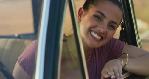 Smiling Young Woman in Car on Road Trip