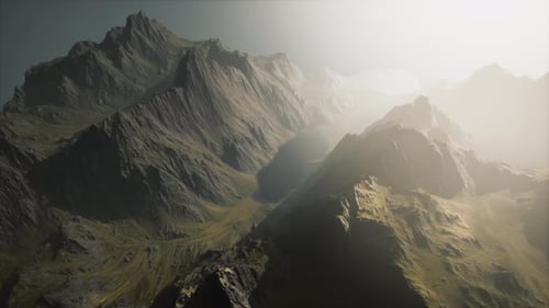 A Breathtaking Aerial View of Majestic Sunlit Mountain Peaks