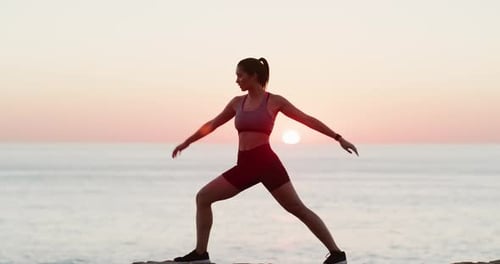 Woman Exercising on Beach at Sunrise
