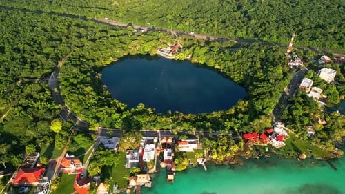 Aerial view of stunning shallow water lagoon beside small tropical village