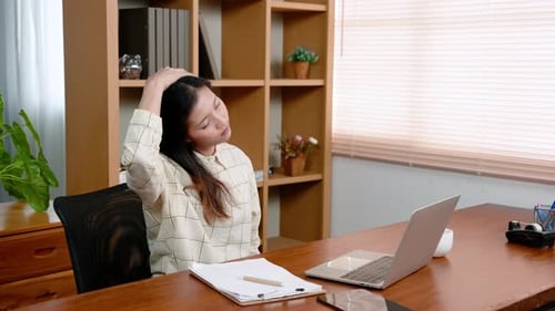 Young Asian woman, office worker, sitting in front laptop computer, at table in home office room, wo