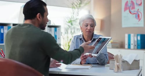 Doctor Explains X-Ray to Patient in Medical Office