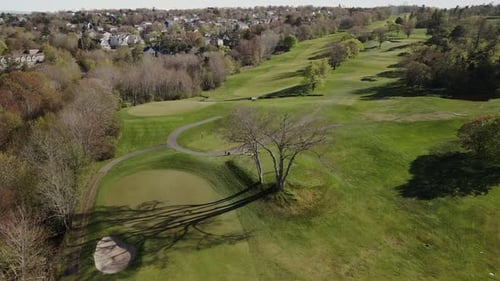 Golf Course Aerial Shot Players Enjoying Game And Groundskeepers Tending Greens