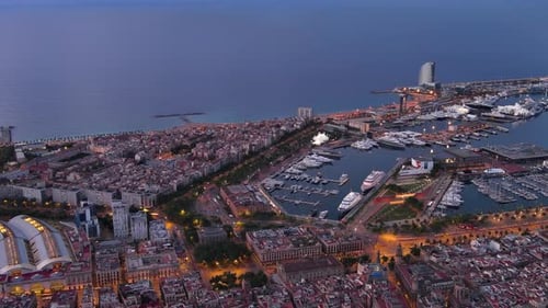 Aerial view of Gothic Quarter and La Barceloneta at dusk in Barcelona, Catalonia, Spain