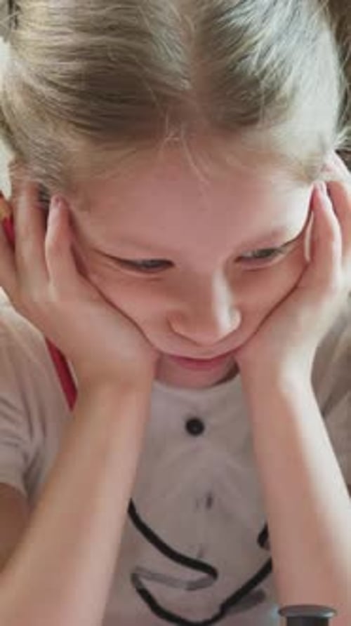 Blonde Girl Focused at Home Close Up