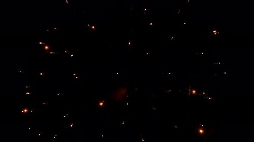 Close up view of fireworks bursting into colorful sparkling light in the night sky. Pyrotechnic show