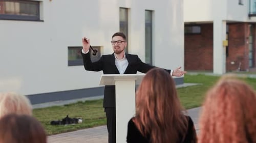 Man Speaks at Podium with Gavel at Auction