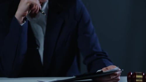 Young Woman Reviewing Legal Documents with Gavel