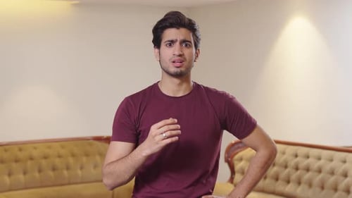 Young Man Thinking and Looking at Camera