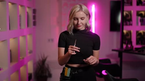 Hair Stylist Inspecting Scissors in Salon