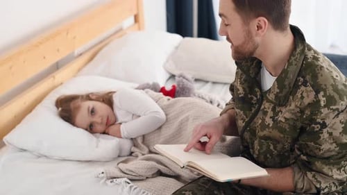 Man in Military Uniform Reading Story to Child